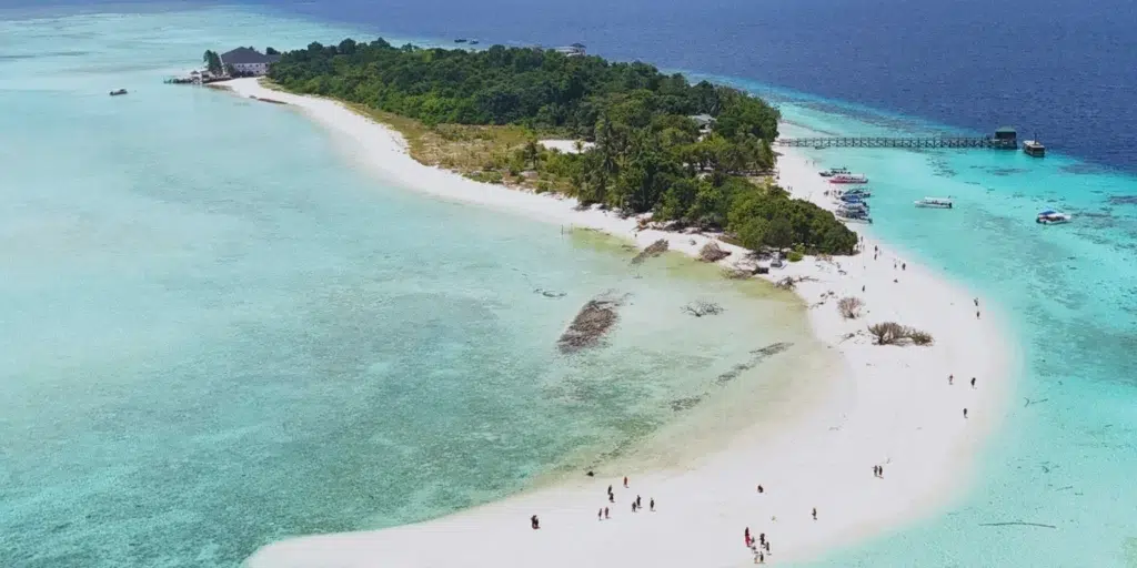 Top view of Semporna's tropical beach with clear turquoise waters and white sand