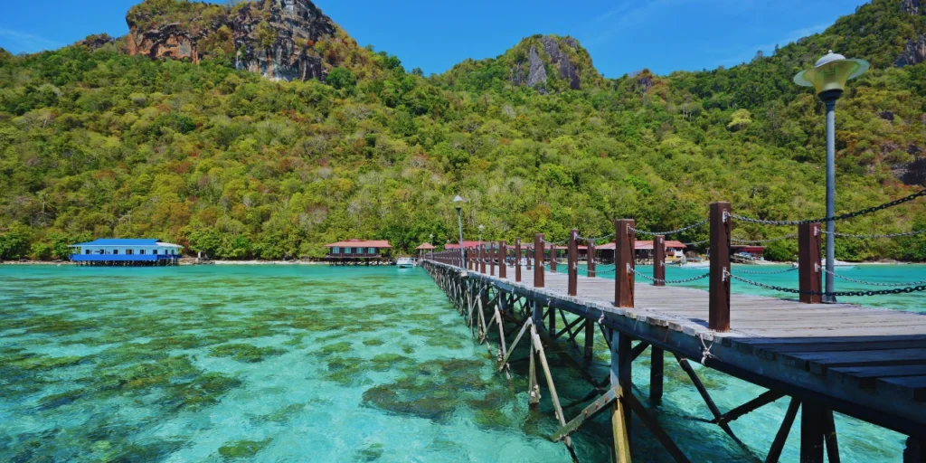 Wooden elevated walkway over the turquoise sea of Sibuan Island