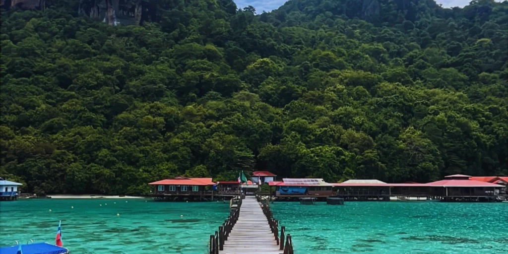 Lush forest and wooden elevated walkway above the sea at Bohey Dulang