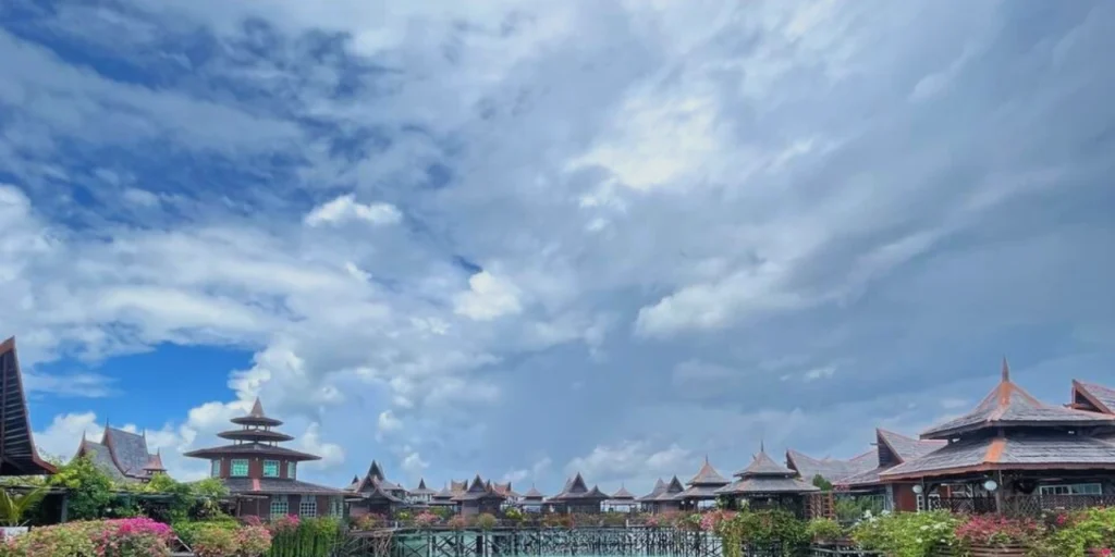 A scenic view of Mabul Water Bungalow with dramatic clouds in the sky