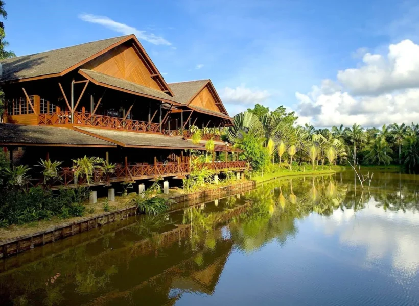 Cozy wooden chalets surrounded by tropical greenery at Sepilok Nature Lodge