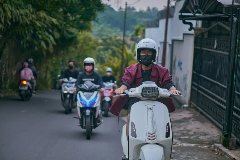 visitor riding a motorcycle with the locals to connect with their lifestyle- the best sandakan guide for solo travelers
