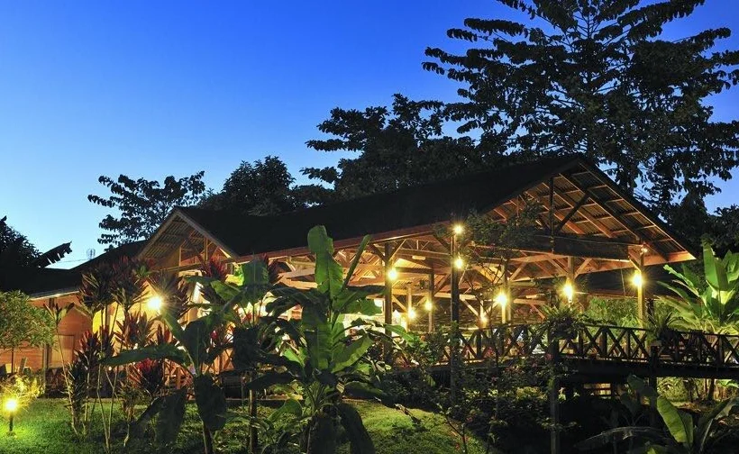 Night view of Sepilok Forest Edge Resort in Sandakan, with warm glowing lights illuminating the resort surrounded by nature.