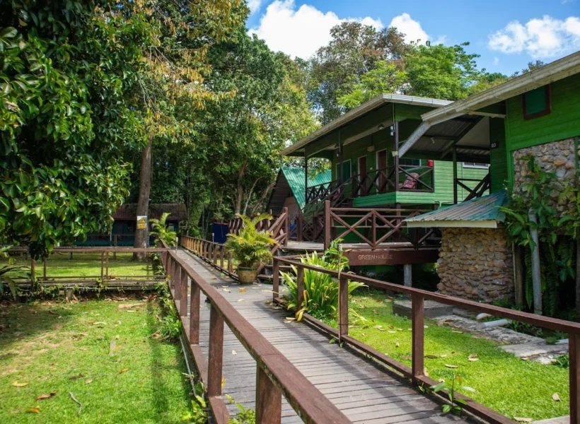 Exterior view of Sukau Greenview Bed & Breakfast in Sukau, a budget-friendly accommodation surrounded by lush greenery